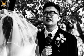 Black and white photo capturing the groom’s emotional reaction during a winter garden wedding near Beijing.